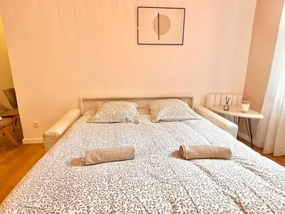 a bedroom with a bed with two pillows on it at Le Palme d'Or, 3 pièces - impasse privée - 7 pers in Cannes