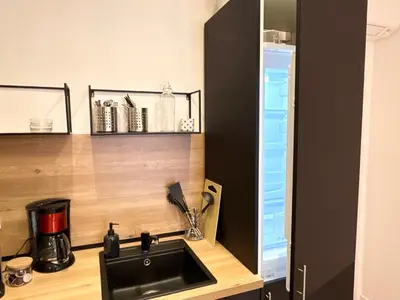 a kitchen with a sink and a counter top at Le Palme d'Or, 3 pièces - impasse privée - 7 pers in Cannes