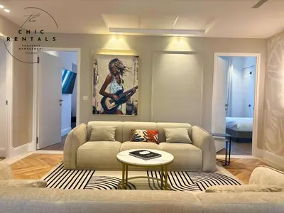a bedroom with a large white bed and a window at SCARLETT 4 Bedroom next to the Croisette in Cannes