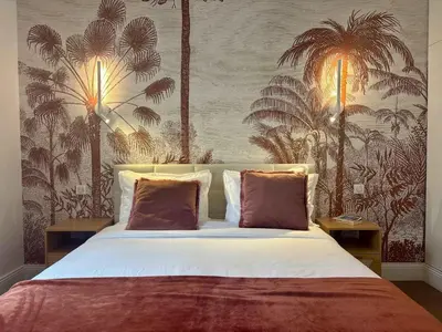 a bedroom with a bed and a chair and windows at SCARLETT 4 Bedroom next to the Croisette in Cannes