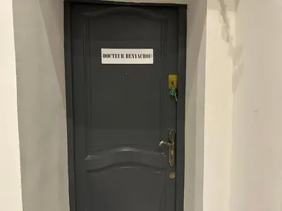 a black door with a sign on it at Cannes centre ville en face du port in Cannes