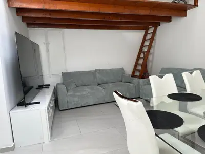 a living room with a couch and a table at Cannes centre ville en face du port in Cannes