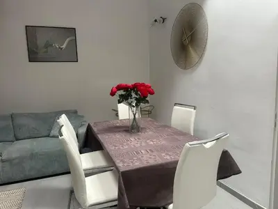 a living room with a couch and a man in a mirror at Cannes centre ville en face du port in Cannes