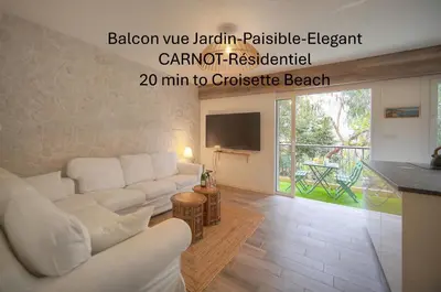 a living room with a white couch and a tv at Calme 2 Chambres BALCON VUE JARDIN-CARNOT A2B266 in Cannes