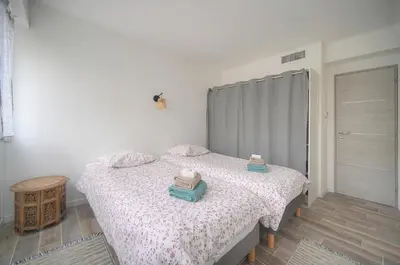 a bedroom with a bed with two towels on it at Calme 2 Chambres BALCON VUE JARDIN-CARNOT A2B266 in Cannes