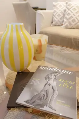 a magazine and a vase on a coffee table at Palais Riviera in Cannes