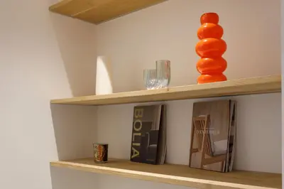 a wooden shelf with glasses and a vase on it at Palais Riviera in Cannes