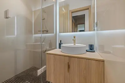 a white bathroom with a sink and a mirror at REF 2032 Renovated apartment-Sea view -Ideal for conferences and vacations in Cannes