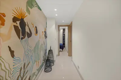 a hallway with a mural of birds on the wall at REF 2032 Renovated apartment-Sea view -Ideal for conferences and vacations in Cannes