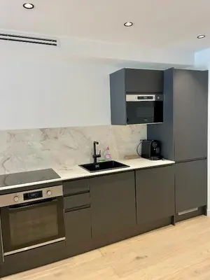 a kitchen with a sink and a stove top oven at T2 chic et moderne à deux pas de la Croisette in Cannes
