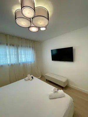 a bedroom with a bed and a flat screen tv at T2 chic et moderne à deux pas de la Croisette in Cannes