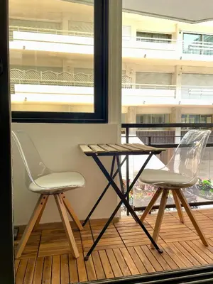 two chairs and a table on a balcony at T2 chic et moderne à deux pas de la Croisette in Cannes