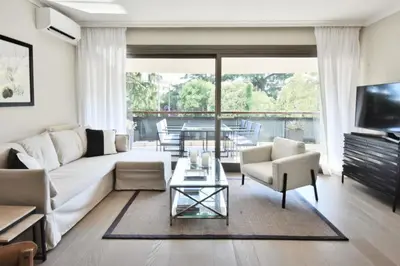 a living room with a white couch and a table at Résidence Cannes - 3p Neuf à 15min à Pied De La Plage - CANNES - 3P neuf à 15min à pied de la plage MAE-2383 in Cannes