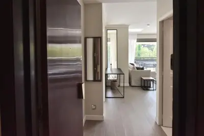 a hallway with a living room with a couch and a table at Résidence Cannes - 3p Neuf à 15min à Pied De La Plage - CANNES - 3P neuf à 15min à pied de la plage MAE-2383 in Cannes