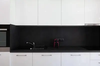 a kitchen with white cabinets and a black counter top at Résidence 3p Avec Terrasse Au Palm Beach, à 2min Des Plages - 3P avec terrasse au Palm Beach, à 2min des plages MAE-1553 in Cannes