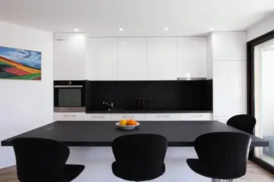 a kitchen with a black table and black chairs at Résidence 3p Avec Terrasse Au Palm Beach, à 2min Des Plages - 3P avec terrasse au Palm Beach, à 2min des plages MAE-1553 in Cannes