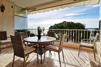 a patio with a table and chairs on a balcony at Résidence 4p Terrasse & Vue Mer, Plage à 5 Min - 4P terrasse & vue mer, plage à 5 min MAE-1563 in Cannes