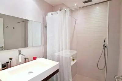 a white bathroom with a shower and a sink at Résidence 4p Terrasse & Vue Mer, Plage à 5 Min - 4P terrasse & vue mer, plage à 5 min MAE-1563 in Cannes