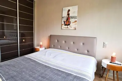 a bedroom with a large bed and a table with candles at Résidence 4p Terrasse & Vue Mer, Plage à 5 Min - 4P terrasse & vue mer, plage à 5 min MAE-1563 in Cannes