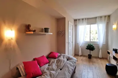 a living room with a couch with pink pillows at Résidence 4p Terrasse & Vue Mer, Plage à 5 Min - 4P terrasse & vue mer, plage à 5 min MAE-1563 in Cannes