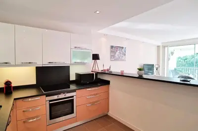 a kitchen with white cabinets and a counter top at Résidence 4p Terrasse & Vue Mer, Plage à 5 Min - 4P terrasse & vue mer, plage à 5 min MAE-1563 in Cannes