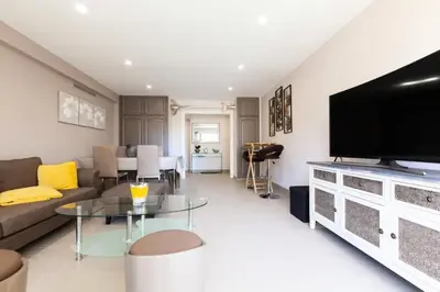 a living room with a couch and a flat screen tv at Résidence 3p Traversant à 2 Min Des Plages, Parking Privé - 3P traversant à 2 min des plages, parking privé MAE-1583 in Cannes