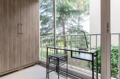 a balcony with a desk and a large window at Résidence 3p Traversant à 2 Min Des Plages, Parking Privé - 3P traversant à 2 min des plages, parking privé MAE-1583 in Cannes