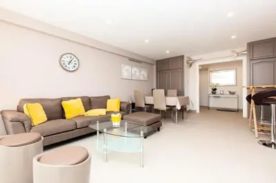 a living room with a couch and a table at Résidence 3p Traversant à 2 Min Des Plages, Parking Privé - 3P traversant à 2 min des plages, parking privé MAE-1583 in Cannes