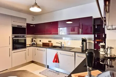 a kitchen with purple cabinets and a sink and a stove at Résidence 3p Avec Terrasse Et Piscine Au Coeur Du Palm Beach - 3P avec terrasse et piscine au coeur du Palm Beach MAE-1593 in Cannes