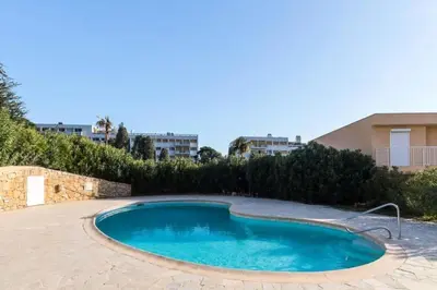 a small swimming pool in a yard with trees and buildings at Résidence Havre De Paix 2 Pièces, Terrasse Vue Mer & Piscine - Havre de paix 2 pièces, terrasse vue mer & piscine MAE-1603 in Cannes