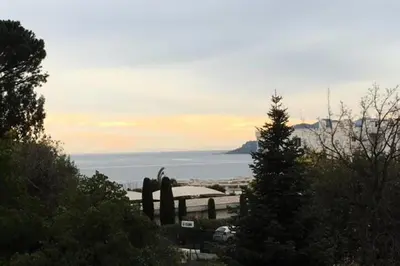 a view of the ocean from a hill with a statue at Résidence Havre De Paix 2 Pièces, Terrasse Vue Mer & Piscine - Havre de paix 2 pièces, terrasse vue mer & piscine MAE-1603 in Cannes