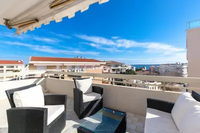 a balcony with chairs and a view of the city at Résidence 3p De Standing, Vue Mer Et Grande Terrasse - 3P de standing, vue mer et grande terrasse MAE-1613 in Cannes