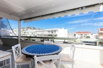 a table and chairs on a balcony with a view at Résidence 3p De Standing, Vue Mer Et Grande Terrasse - 3P de standing, vue mer et grande terrasse MAE-1613 in Cannes