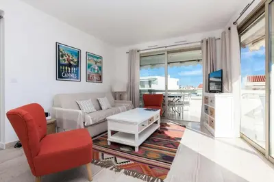 a living room with a couch and a table at Résidence 3p De Standing, Vue Mer Et Grande Terrasse - 3P de standing, vue mer et grande terrasse MAE-1613 in Cannes