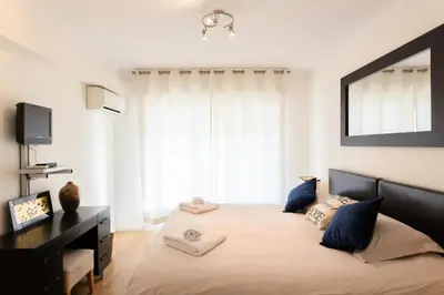 a bedroom with a large bed with blue pillows at Résidence 3p à 2 Min De La Rue D’antibes Et Des Plages - 3P à 2 min de la rue d’Antibes et des Plages MAE-1623 in Cannes