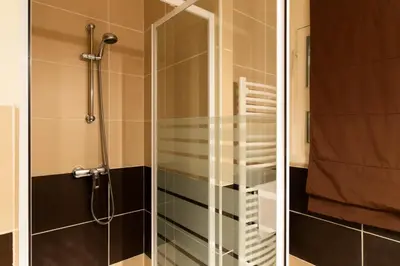 two pictures of a shower with a glass door at Résidence 3p à 2 Min De La Rue D’antibes Et Des Plages - 3P à 2 min de la rue d’Antibes et des Plages MAE-1623 in Cannes