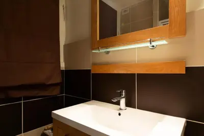 a bathroom with a white sink and a mirror at Résidence 3p à 2 Min De La Rue D’antibes Et Des Plages - 3P à 2 min de la rue d’Antibes et des Plages MAE-1623 in Cannes