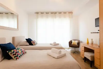 a bedroom with two beds and a desk and a window at Résidence 3p à 2 Min De La Rue D’antibes Et Des Plages - 3P à 2 min de la rue d’Antibes et des Plages MAE-1623 in Cannes