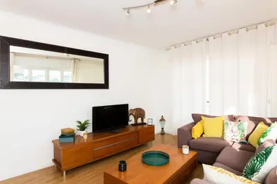 a living room with a couch and a tv at Résidence 3p à 2 Min De La Rue D’antibes Et Des Plages - 3P à 2 min de la rue d’Antibes et des Plages MAE-1623 in Cannes
