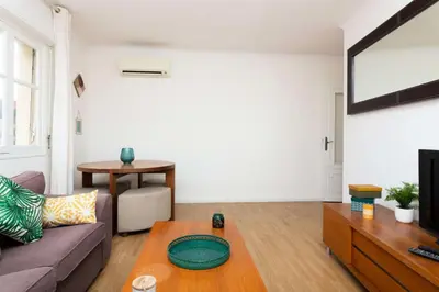 a living room with a couch and a table at Résidence 3p à 2 Min De La Rue D’antibes Et Des Plages - 3P à 2 min de la rue d’Antibes et des Plages MAE-1623 in Cannes