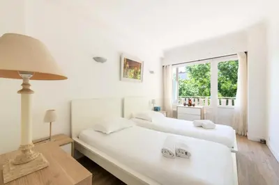 two white beds in a room with a window at Résidence 3p Cosy, 6 Minutes à Pied Des Plages - 3P cosy, 6 minutes à pied des plages MAE-1633 in Cannes