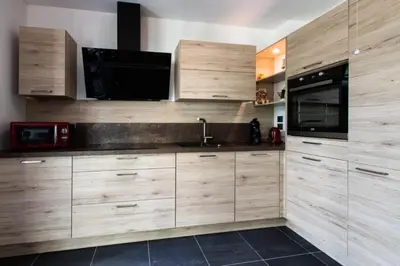 a kitchen with wooden cabinets and a sink and a microwave at Résidence 3p Avec Jardin Et Piscine Au Coeur Du Palm Beach - 3P avec jardin et piscine au coeur du Palm Beach MAE-1643 in Cannes