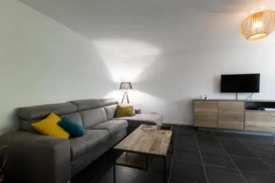 a living room with a couch and a tv at Résidence 3p Avec Jardin Et Piscine Au Coeur Du Palm Beach - 3P avec jardin et piscine au coeur du Palm Beach MAE-1643 in Cannes