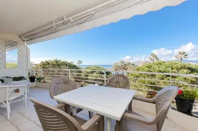 a table and chairs on a balcony with a view of the ocean at Résidence Vue Mer, Cannes Croisette, Au Pied Des Plages - Vue Mer, Cannes Croisette, au Pied des Plages MAE-1653 in Cannes