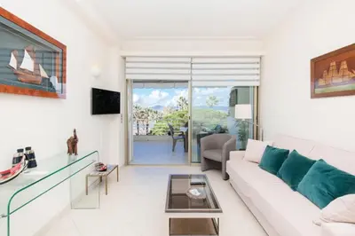 a living room with a couch and a table at Résidence Vue Mer, Cannes Croisette, Au Pied Des Plages - Vue Mer, Cannes Croisette, au Pied des Plages MAE-1653 in Cannes