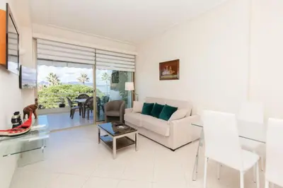 a living room with a couch and a table at Résidence Vue Mer, Cannes Croisette, Au Pied Des Plages - Vue Mer, Cannes Croisette, au Pied des Plages MAE-1653 in Cannes