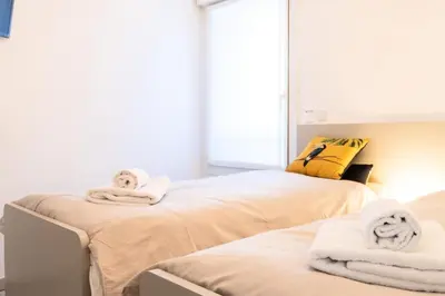 a room with two beds with towels on them at Résidence 3p Terrasse Et Piscine à 15min à Pied Du Palais - 3P terrasse et piscine à 15min à pied du Palais MAE-1663 in Cannes