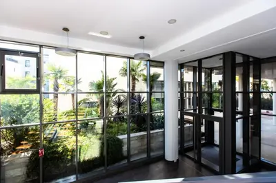a room with large windows and a view of palm trees at Résidence 3p Terrasse Et Piscine à 15min à Pied Du Palais - 3P terrasse et piscine à 15min à pied du Palais MAE-1663 in Cannes