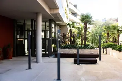 a building with a bench in front of a building at Résidence 3p Terrasse Et Piscine à 15min à Pied Du Palais - 3P terrasse et piscine à 15min à pied du Palais MAE-1663 in Cannes