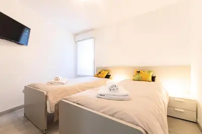 two beds with towels on them in a bedroom at Résidence 3p Terrasse Et Piscine à 15min à Pied Du Palais - 3P terrasse et piscine à 15min à pied du Palais MAE-1663 in Cannes